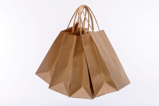 Brown paper shopping bags on white background. Empty area.