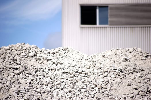 A pile of heaped up and crushed concrete rubble.
