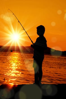 an image of a boy fishing at sunset