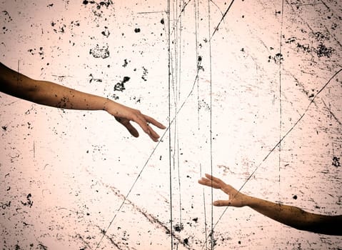 An image of hands reaching each other.