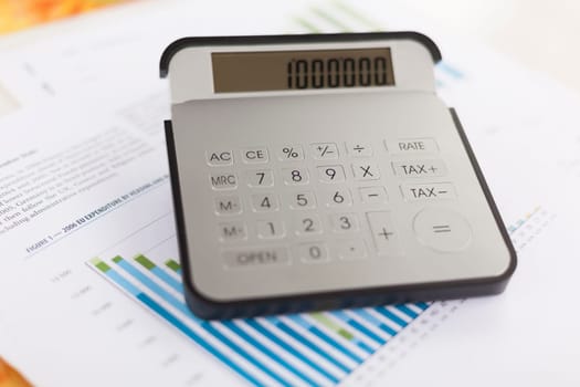 Business analysis - Checking accounting report on business table with calculator