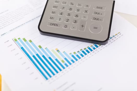 Business analysis - Checking accounting report on business table with calculator