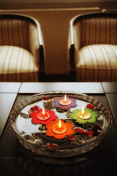 close up shot of floating candles in glass bowl.