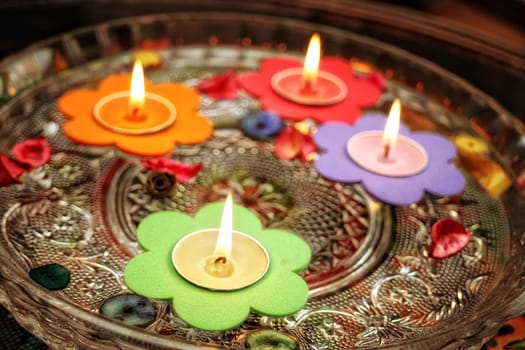 close up shot of floating candles in glass bowl.