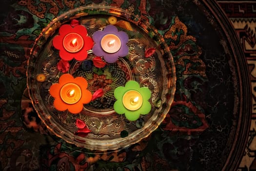 close up shot of floating candles in glass bowl.
