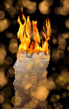 close up shot of burning money pile over black background