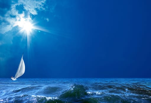 seascape image of sailing boat on sea over sunny sky.