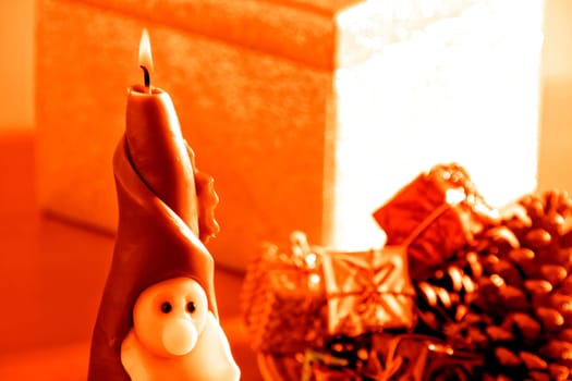 an image of Santa Clause candle and gift boxes in Christmas time