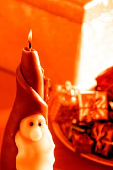 an image of Santa Clause candle and gift boxes in Christmas time