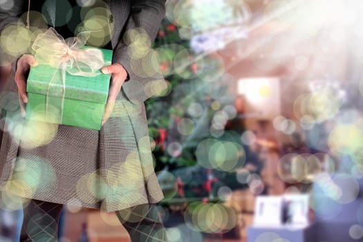 an image of a woman holding giftbox and Christmas tree