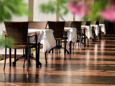 close up shot of outdoor empty restaurant table and chairs.