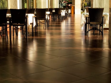 close up shot of outdoor empty restaurant table and chairs.
