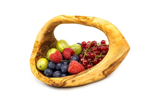 Wooden basket with berries,various fruits isolated on a white background