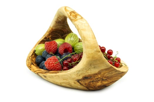 Wooden basket with berries,various fruits isolated on a white background