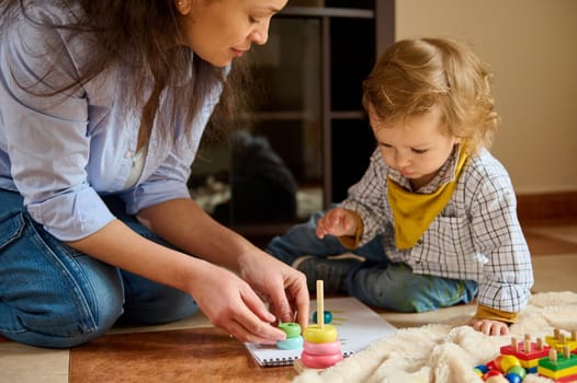 A mother and child learning with creativity, promoting intellectual growth and bonding through engaging educational activities in a nurturing environment.
