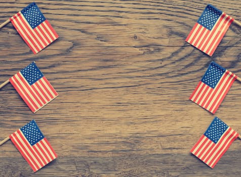 Small American flags on a rustic wooden background