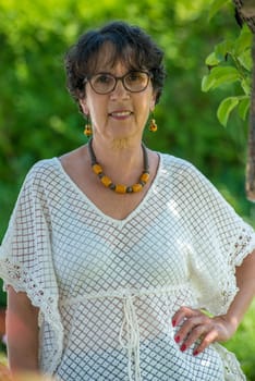 a portrait of a beautiful senior woman in the garden