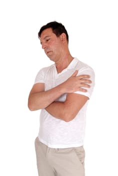 A tall handsome middle age man standing in a beige slacks and white.t-shirt with his arms crossed, isolated for white background.