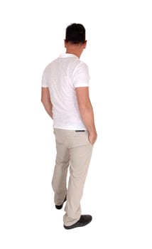 A tall handsome middle age man standing in a beige slacks and white t-shirt .with his hands in his pocket, from the back, isolated for white background.
