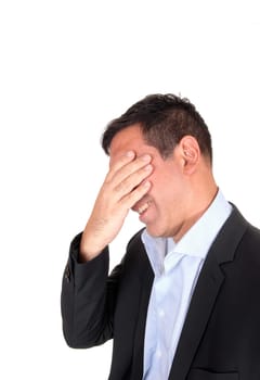 A close up image om a businessman in profile in a suit covering his face,.suffering from pain, isolated for white background.