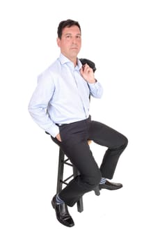 A tall middle age business man sitting on a chair with his jacket over.his shoulder and hand in pocket, isolated for white background.