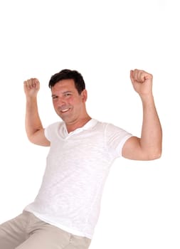 A handsome happy man lifting up his fists and smiling for victory over his.success and celebrates win, isolated for white background.
