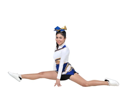 Beautiful asian cheerleader doing splits isolated over white background