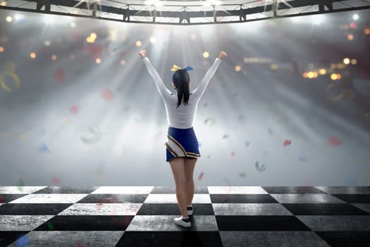 Rear view of asian cheerleader with happy expression on the stage