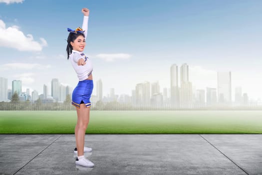 Young asian cheerleader performing at outdoor
