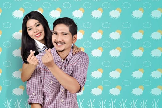 Romantic asian couple showing money sign over summer background