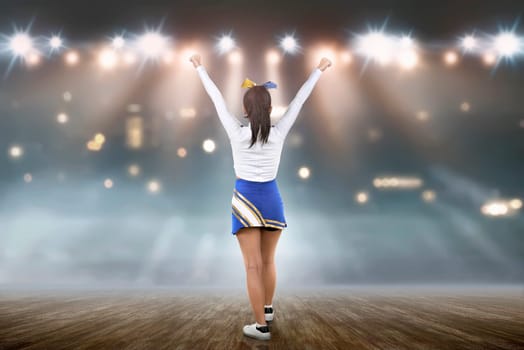 Rear view of asian cheerleader in white and blue suit on the stage