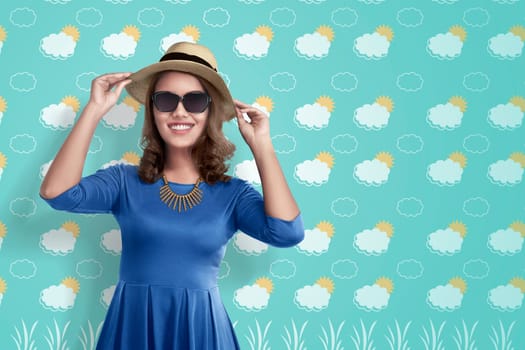 Pretty asian tourist woman with hat and blue shirt over summer background