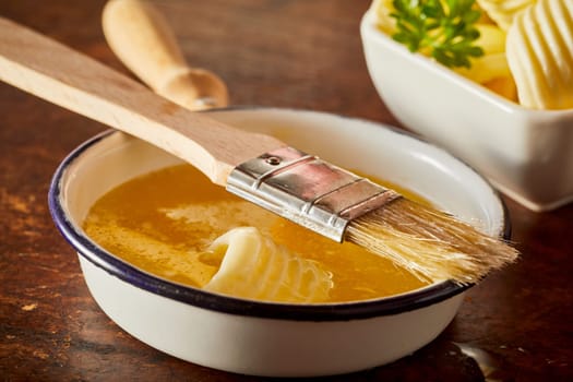 Baking food preparation scene with melted butter in a pan as an ingredient for cakes, bbq sauces and other cooking expriences.