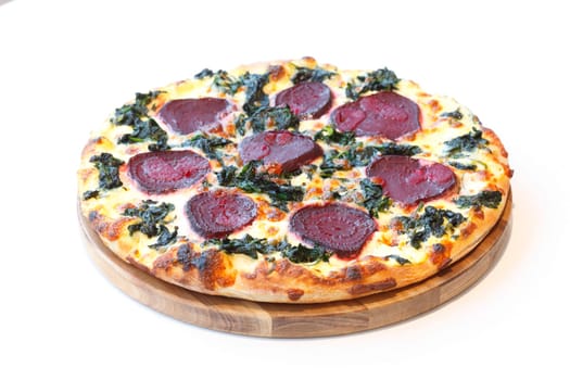 Pizza with beetroot,spinach and cheese,on a wooden board,wise background