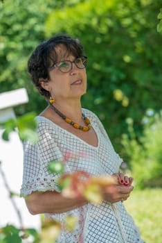 a portrait of a beautiful senior woman in the garden