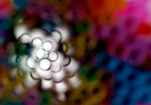 Abstract image showing colorful rings and wihite area off centre ideal for backdrops