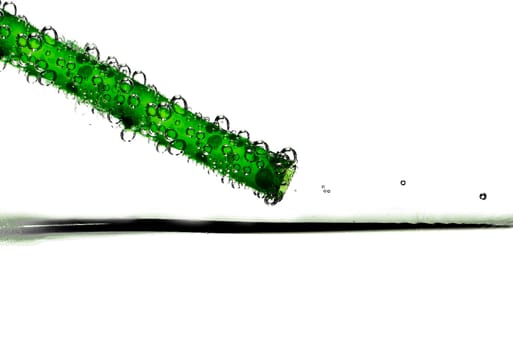 Abstract image showing a green drinking straw with bubbles
