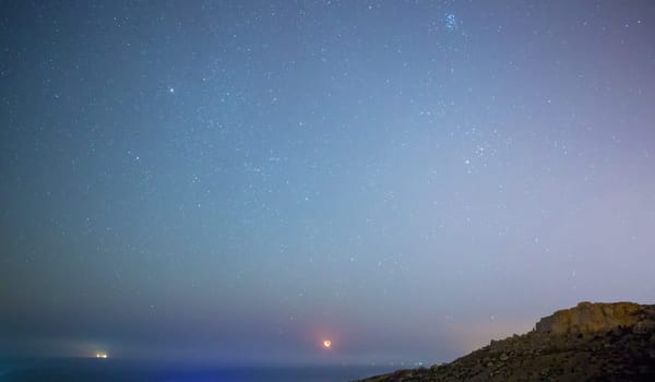 The crescent Moon rises over Mgiebah Bay in Malta