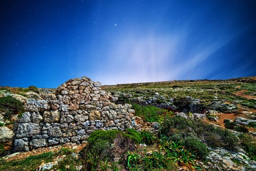 Remains of a Punic wall at Ghajn Tuta Cave in Mellieha in Malta, shot by moonlight.