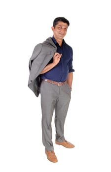 A young East Indian business man standing in a gray suit with his jacket.over his shoulder, smiling, isolated for white background.