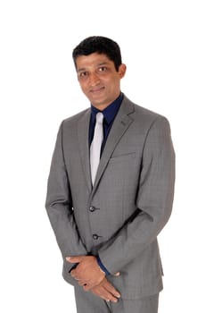 A waist up image of a handsome business man in a gray suit and blue.shirt standing isolated for white background.
