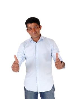 A closeup image on an East Indian man in jeans and blue shirt standing.with booths of his thumps up, isolated for white background.