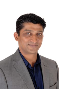 A handsome east Indian businessman in a gray suit and black hair.in a closeup image, isolated for white background.