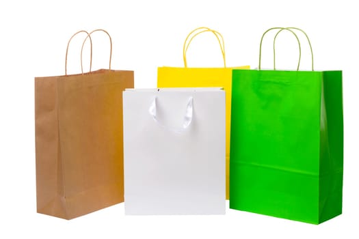 Variety of colored paper shopping bags on white background. Empty area.