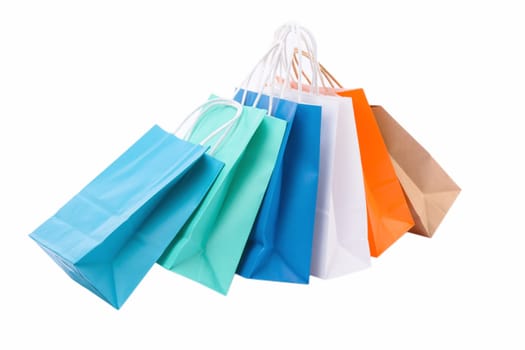 Variety of colored paper shopping bags on white background. Empty area.