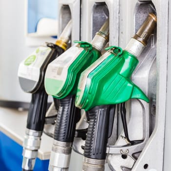 Green gasoline and black diesel distributor at the gas station