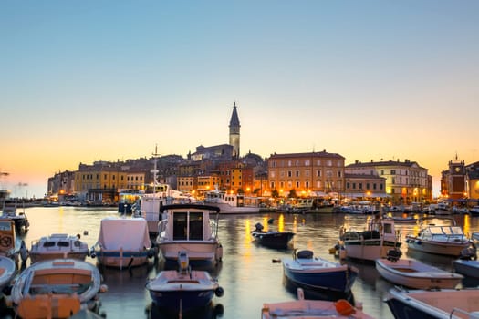 Colorful sunset of Rovinj town, Croatian fishing port on the west coast of the Istrian peninsula. Colorful evening seascape of Adriatic Sea. Traveling concept.