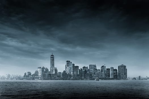 Dramatic panoramic view of storm over Lower Manhattan from Ellis Island at dusk, New York City.