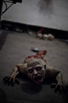 A dismembered zombie or ghoul crawling on the floor