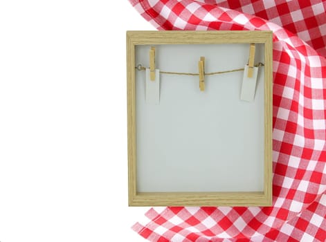 Food recipe template. Empty wooden frame and a red white checkered cloth isolated on white background. For your food and product display montage. Copy space on left side.